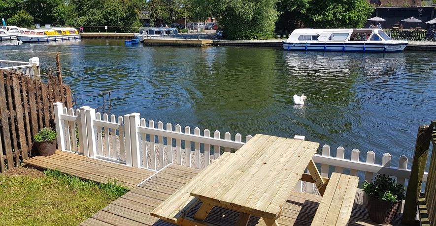 Riverside Cottage waterside decking - perfect for relaxing, fishing or watching the boats